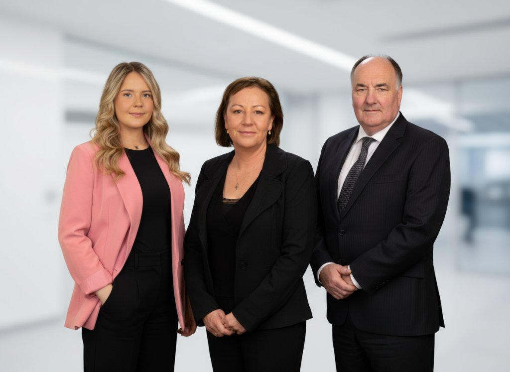 Three employees stand side by side in a power position